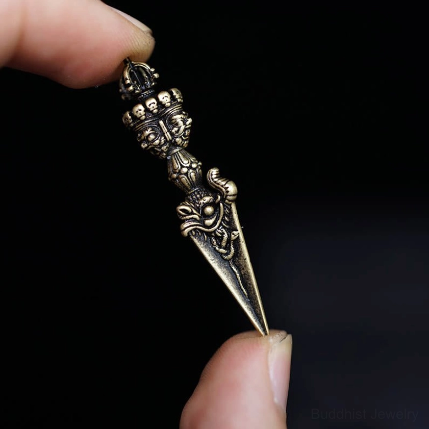Antique bronze vajra pendant with aged patina finish and intricate carved details