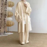 Apricot Buddhist meditation cotton clothing set with frog button shirt and wide-leg pants, front view with traditional lantern studio backdrop