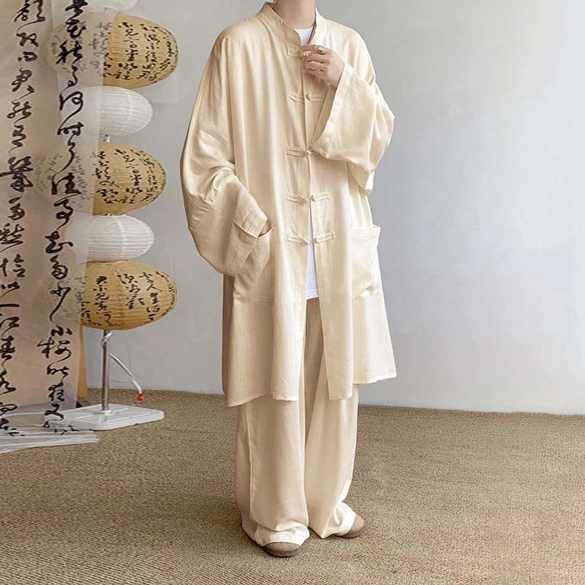 Apricot Buddhist meditation cotton clothing set with frog button shirt and wide-leg pants, front view with traditional lantern studio backdrop