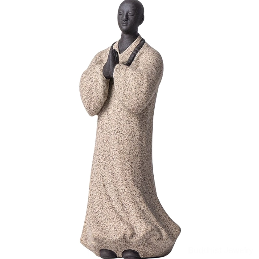 Artisan-made ceramic meditation monk statue showing traditional Buddhist spiritual iconography and craftsmanship