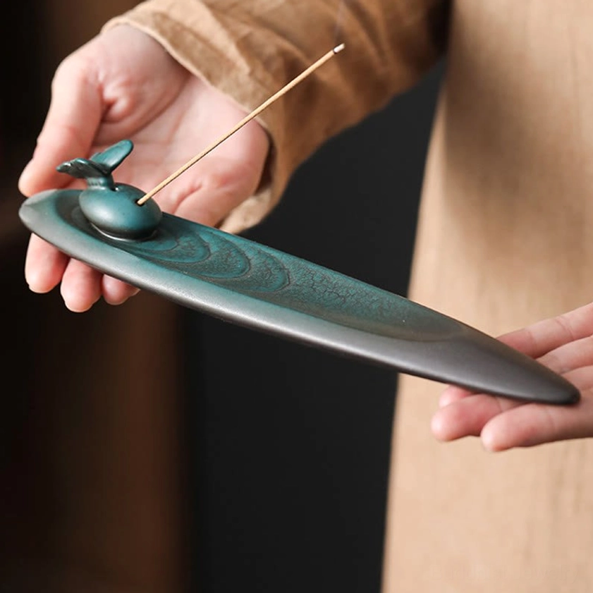 Artisan ceramic incense holder with natural glaze variations showing authentic handmade Buddhist craftsmanship