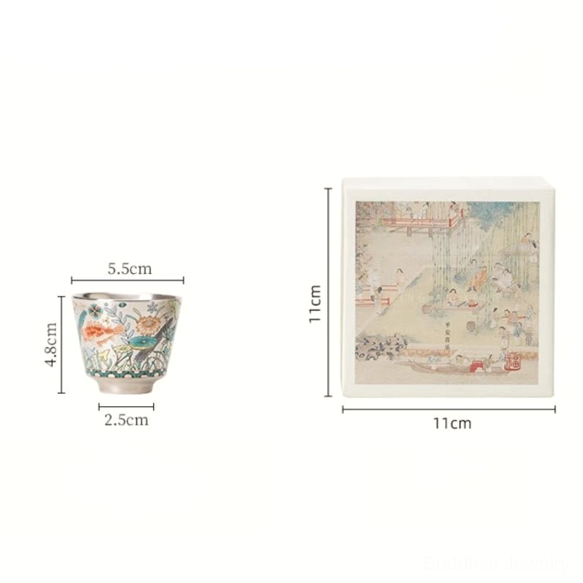 Artisan ceramic gongfu tea cup with traditional fish and floral motifs, close-up detail view
