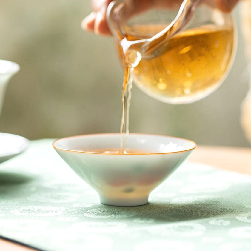 Artisan hand-painted Buddhist ceramic teacup showing detailed craftsmanship and traditional techniques