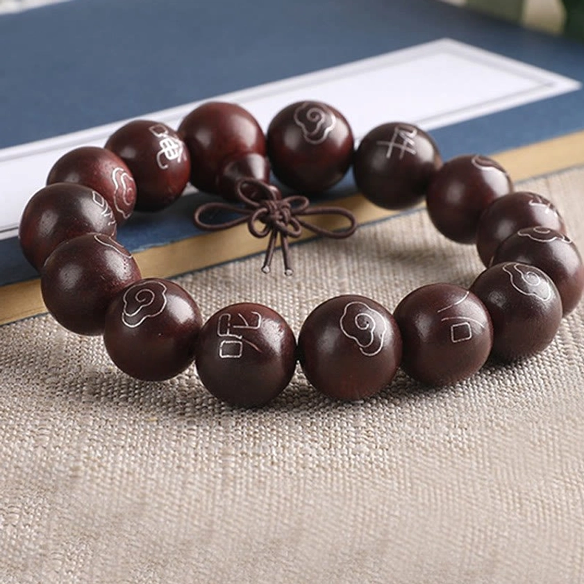 Artisan-crafted red sandalwood mala bracelet with 925 sterling silver sacred character inlays and natural tassel