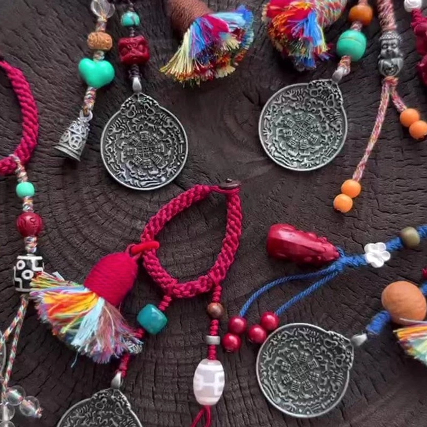 Collection of assorted Buddhist keychains with multiple Dzi Bead styles and colorful rope variations