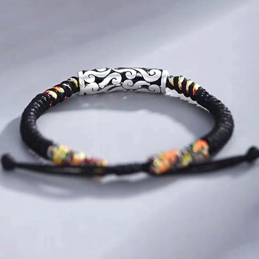 Copper auspicious cloud protection bracelet flat lay overhead view showing full design with cloud-patterned metal bead and colorful woven segments