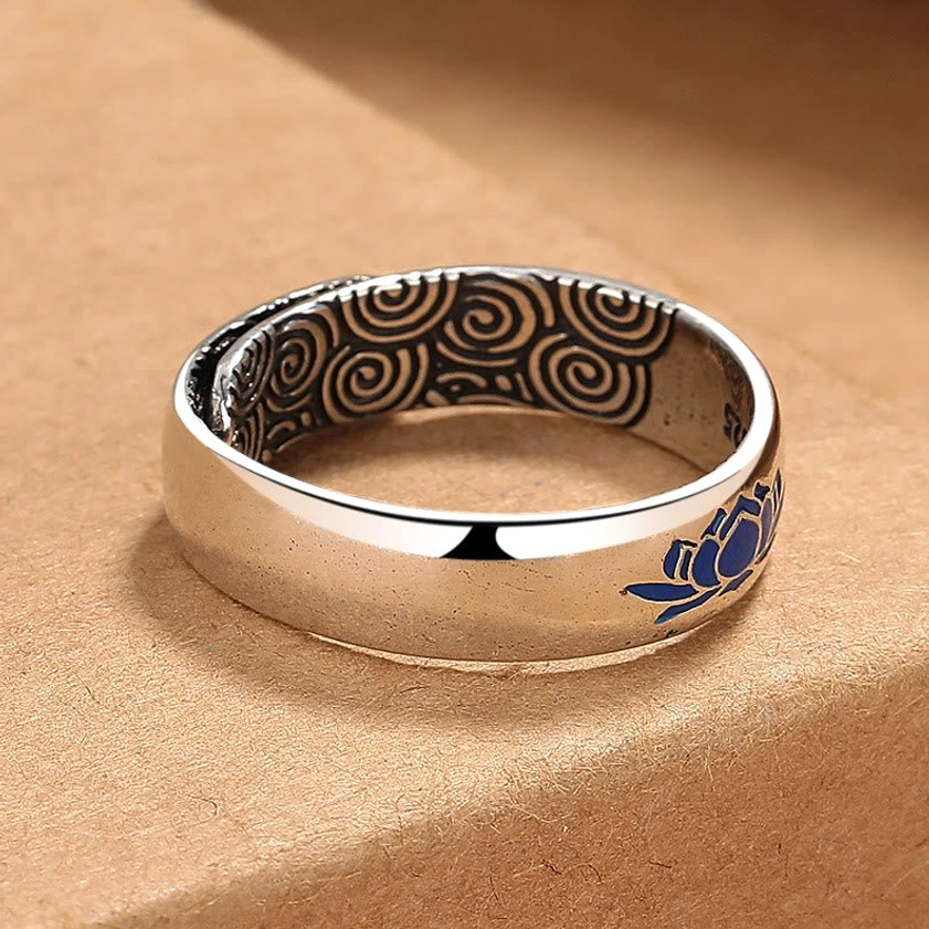 Copper lotus enlightenment ring side profile showing bright silver-toned metal and swirling cloud texture detail