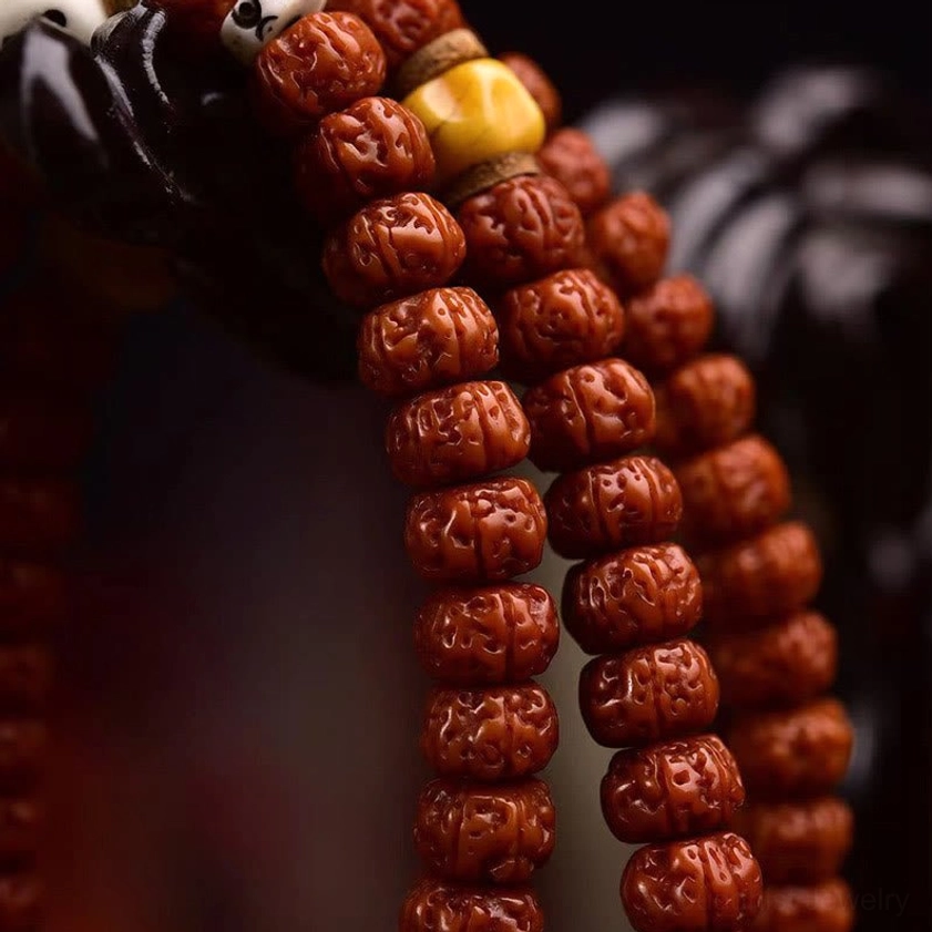 Macro close-up of densely carved ridged bodhi seed surfaces showing authentic texture and natural color variations