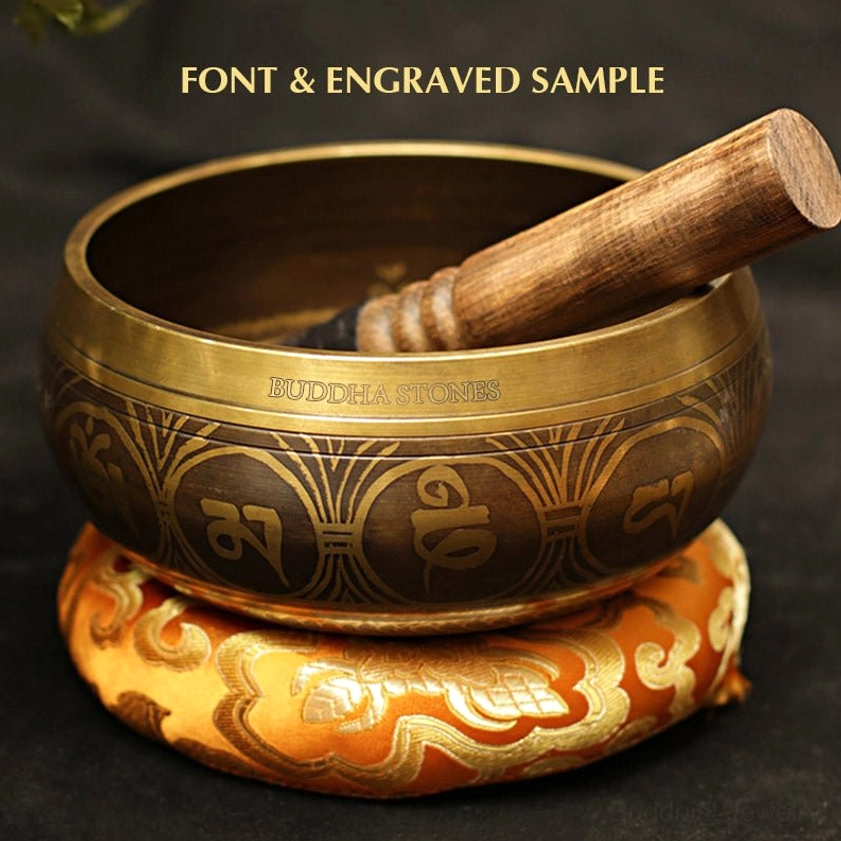 Authentic Buddhist singing bowl with hand-sewn embroidered meditation cushion and wooden striker for mindfulness practice