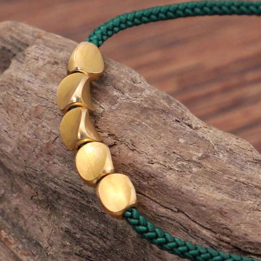 Handmade Buddhist copper bracelet with natural material construction and authentic patina