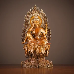 Four-armed Avalokiteshvara brass statue frontal view with flame halo and rock base, antique golden-bronze finish