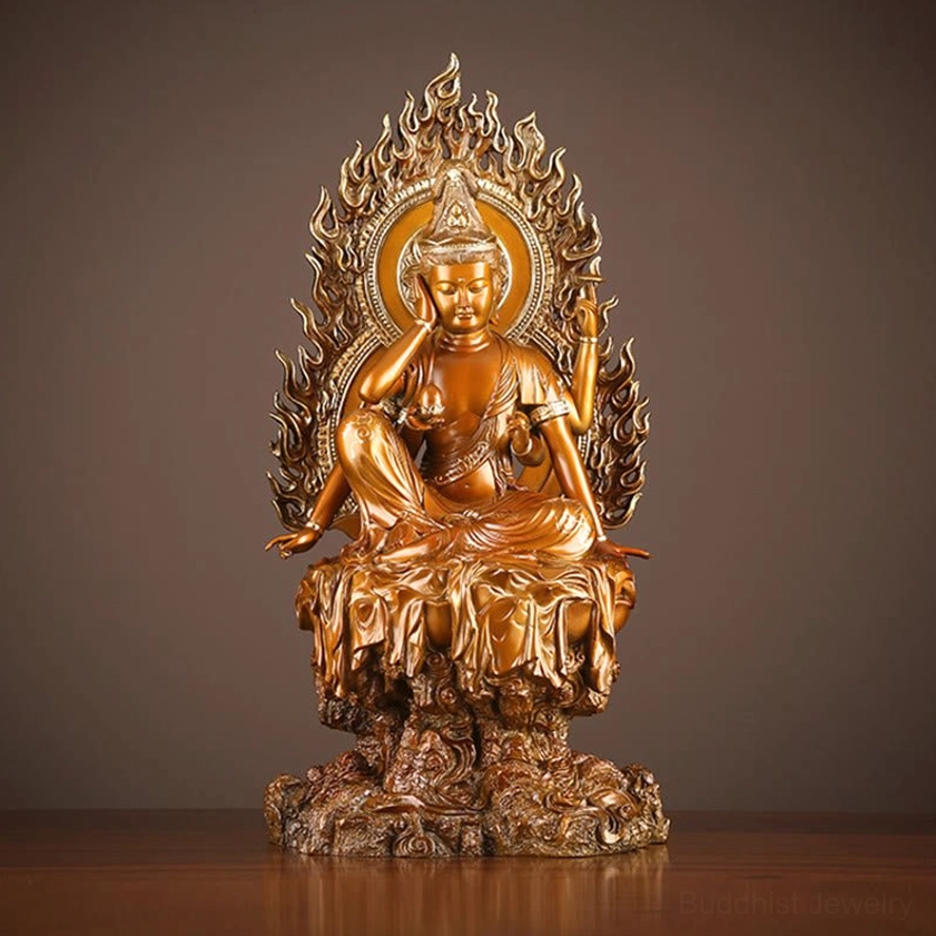 Four-armed Avalokiteshvara brass statue frontal view with flame halo and rock base, antique golden-bronze finish