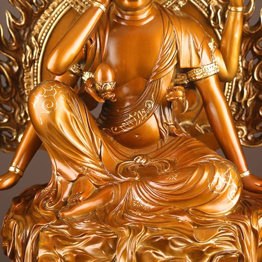 Avalokiteshvara brass statue detail view showing compassion mudras and sacred hand gestures with golden accents