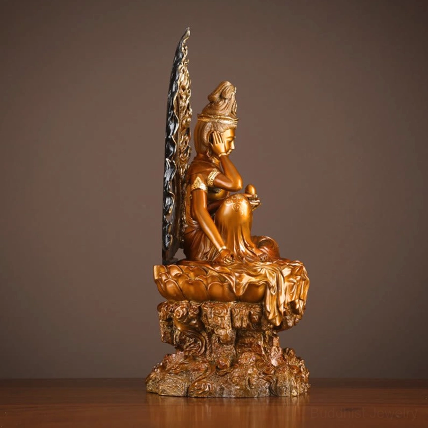 Guanyin Avalokiteshvara statue side view showing lotus and rock dual base with partial flame backplate