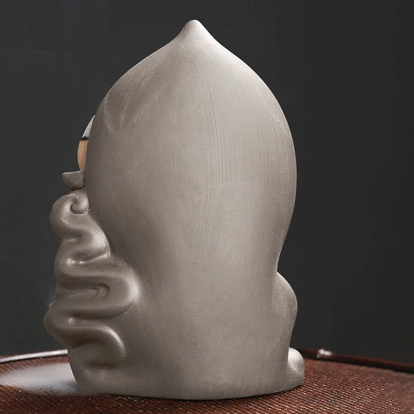 Avalokitesvara Buddha backflow incense burner showcasing intricate carving and ceramic finish