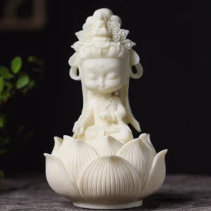 Hand-carved Avalokitesvara Buddha statue with lotus base, front oblique view showing intricate carved details and cream-white finish