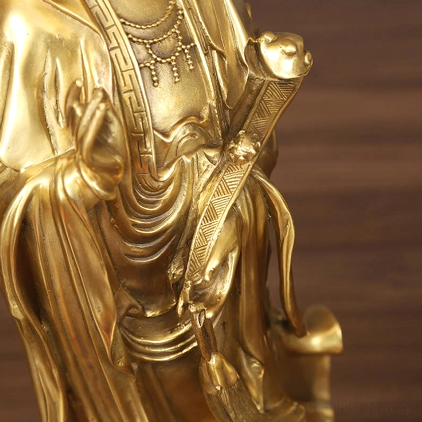 Golden Avalokitesvara brass Buddhist statue showing ornate details of draped robes and traditional ceremonial attire