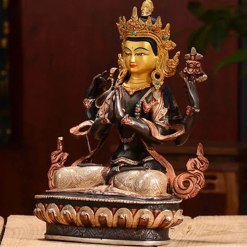 Close-up detail of Avalokitesvara upper body showing gilded face with third eye, inlaid turquoise beads, and prayer hand mudra