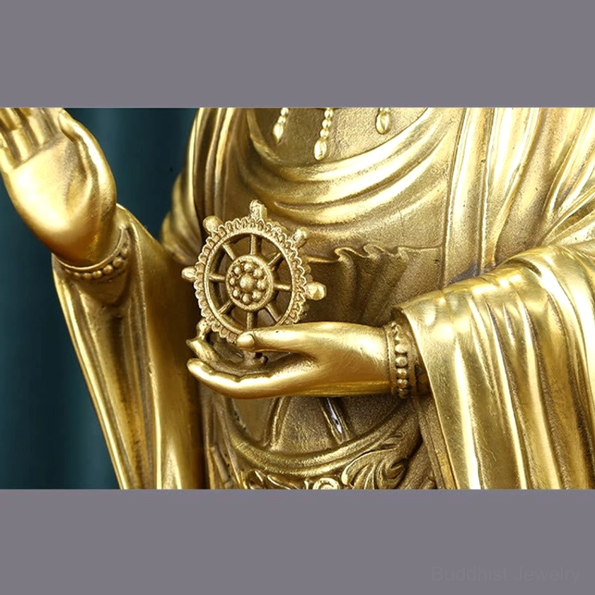Avalokitesvara bodhisattva brass statue angle view dharma wheel compassion symbol
