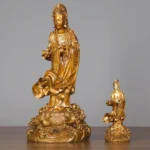 Two sizes of Avalokitesvara Guan Yin brass statues displayed together, showing small and large handcrafted copper bodhisattva figures with lotus-wave bases