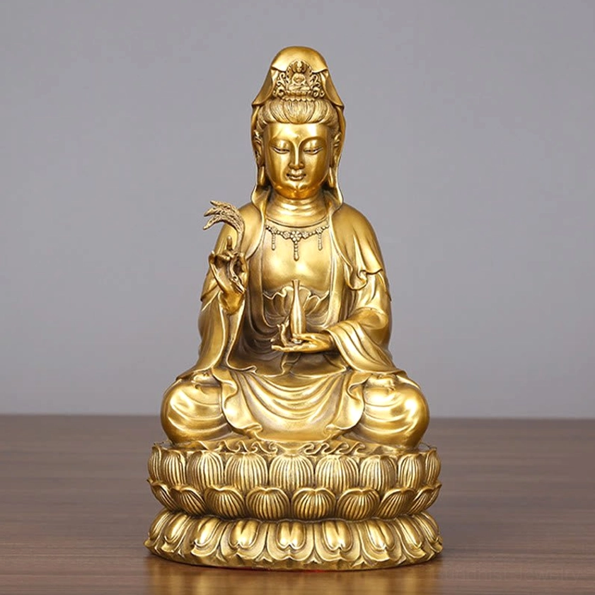 Avalokitesvara Guanyin brass statue with golden gilt finish and lotus pedestal on wooden table