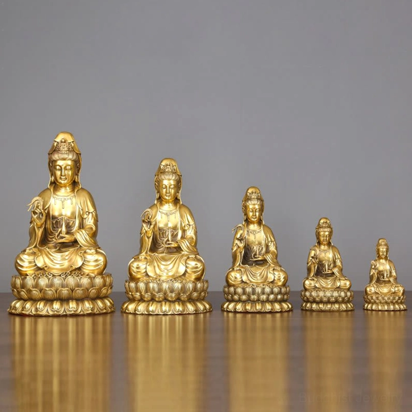 Multiple sizes of Avalokitesvara Guanyin brass statues displayed together on polished wooden table showing size comparison