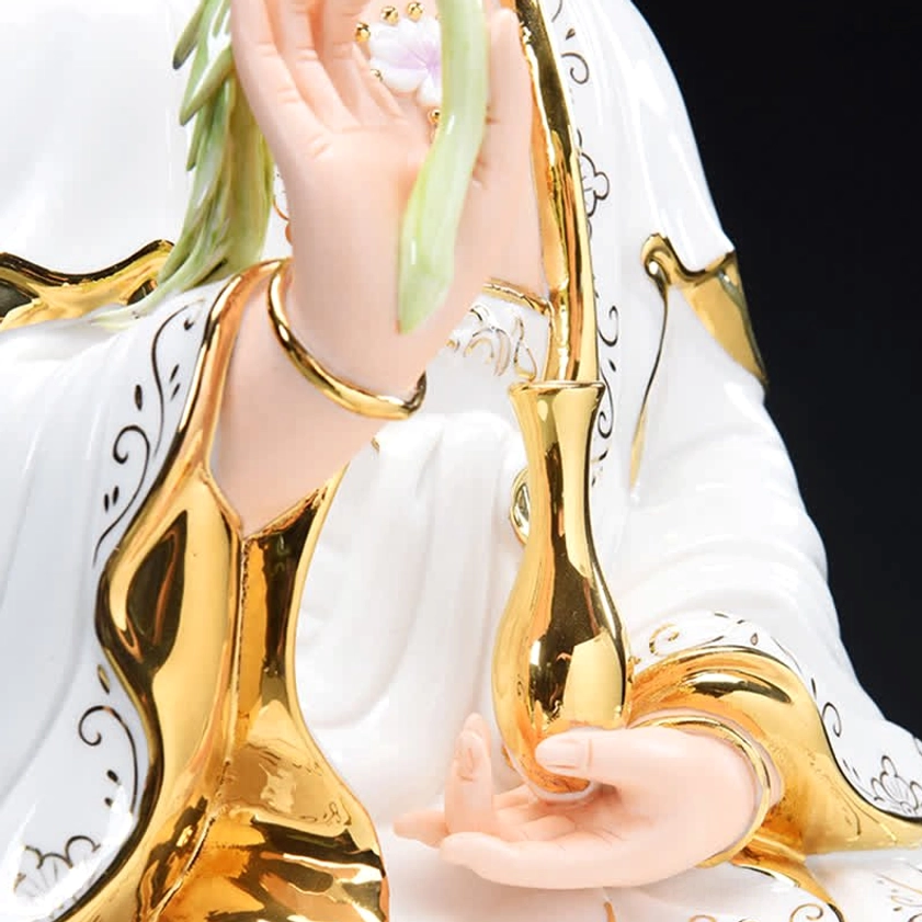 Close-up of Avalokitesvara's hands holding willow sprig holy vase with gold gilt religious details
