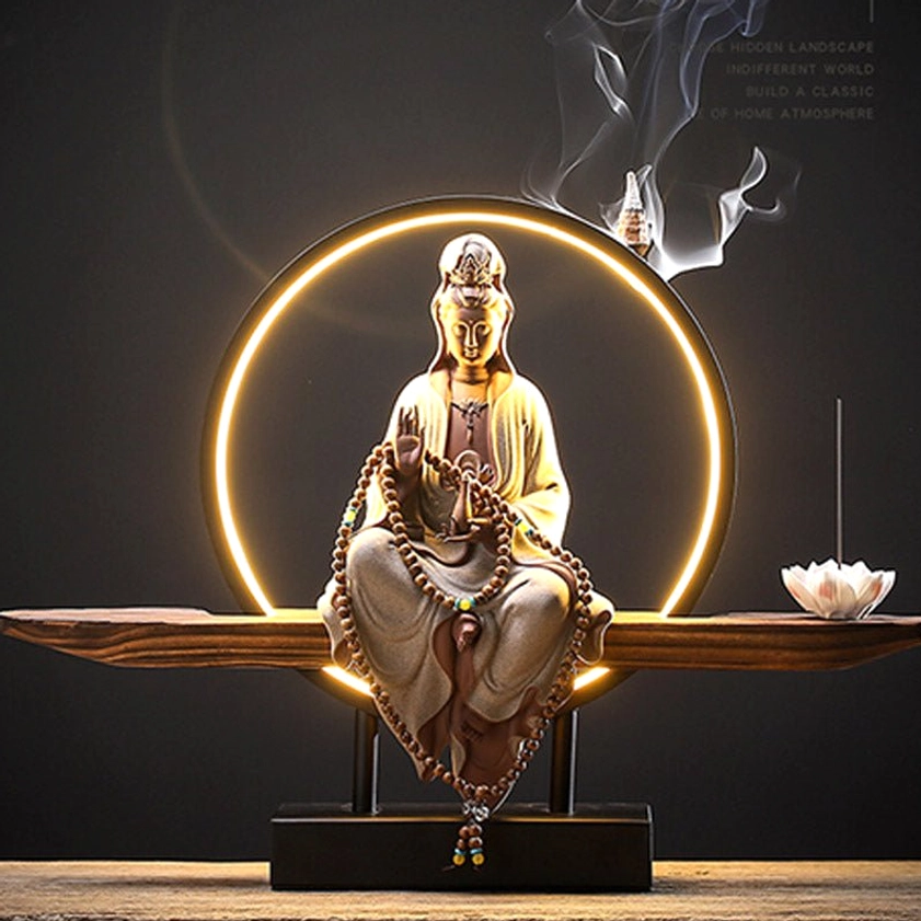 Avalokitesvara Buddhist ceramic incense burner with glowing LED halo creating serene meditation atmosphere