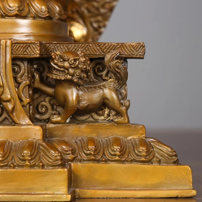 Avalokitesvara statue pedestal base close-up featuring carved foo dog lion guardians and intricate scrollwork details