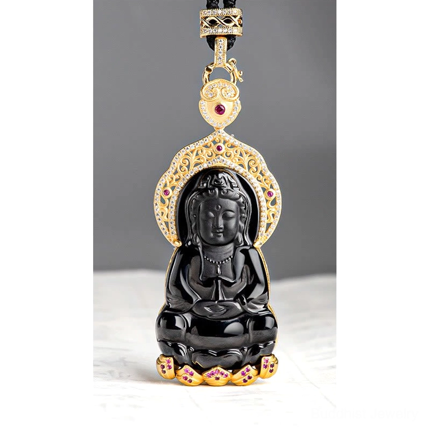 Black jade Guanyin pendant front view with ornate gold-plated filigree frame, accent stones and hanging buckle detail