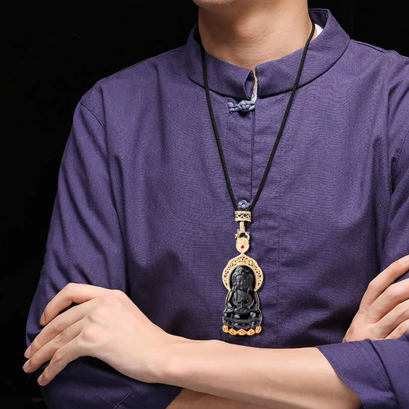 Man wearing black jade Avalokitesvara pendant necklace on black cord over purple traditional top showing real-world wearing style