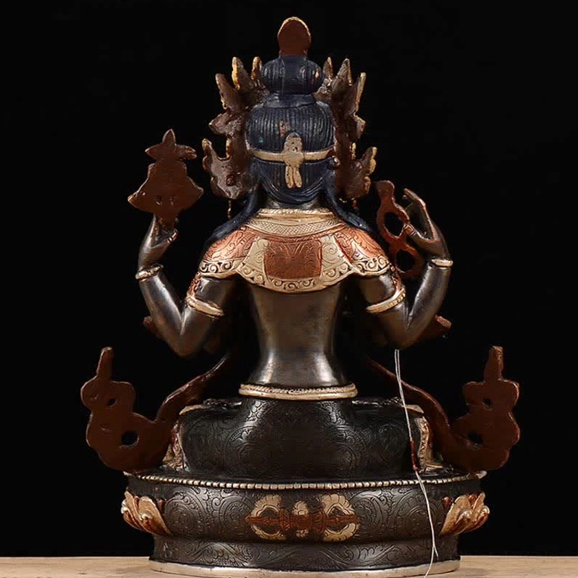 Rear back view of handcrafted Avalokitesvara statue showing engraved lotus throne patterns and ritual implements
