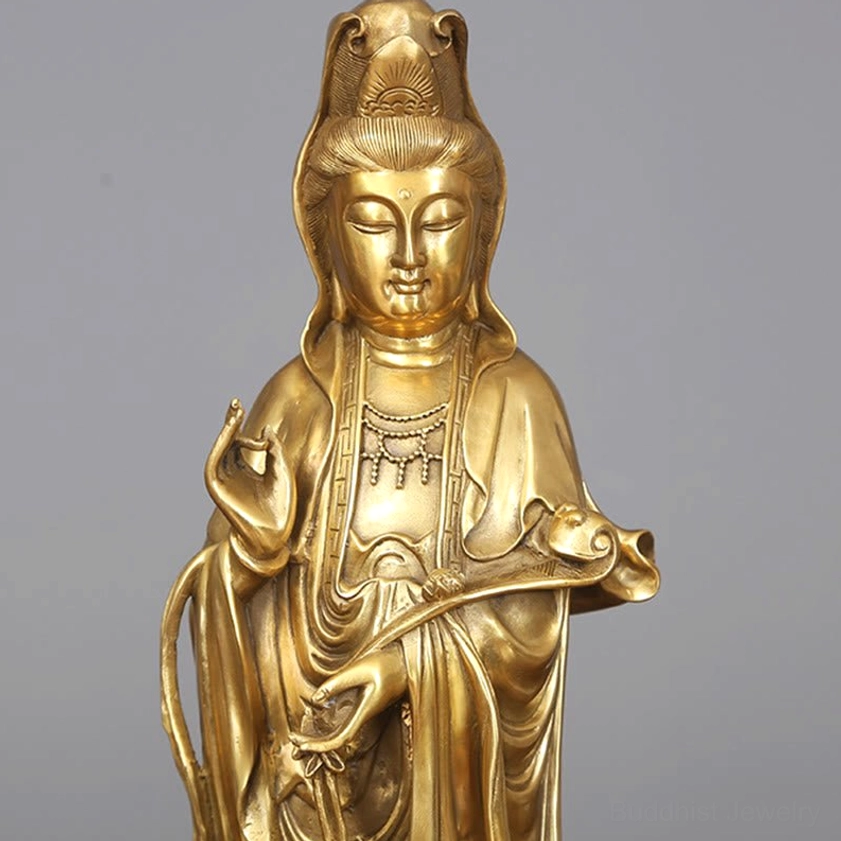 Close-up frontal view of Avalokitesvara statue face, serene expression with ornate headpiece and chest jewelry details