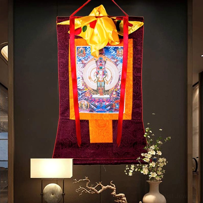 Compassion Buddhist thangka wall hanging displayed in modern living room with lamp and decorative flowers