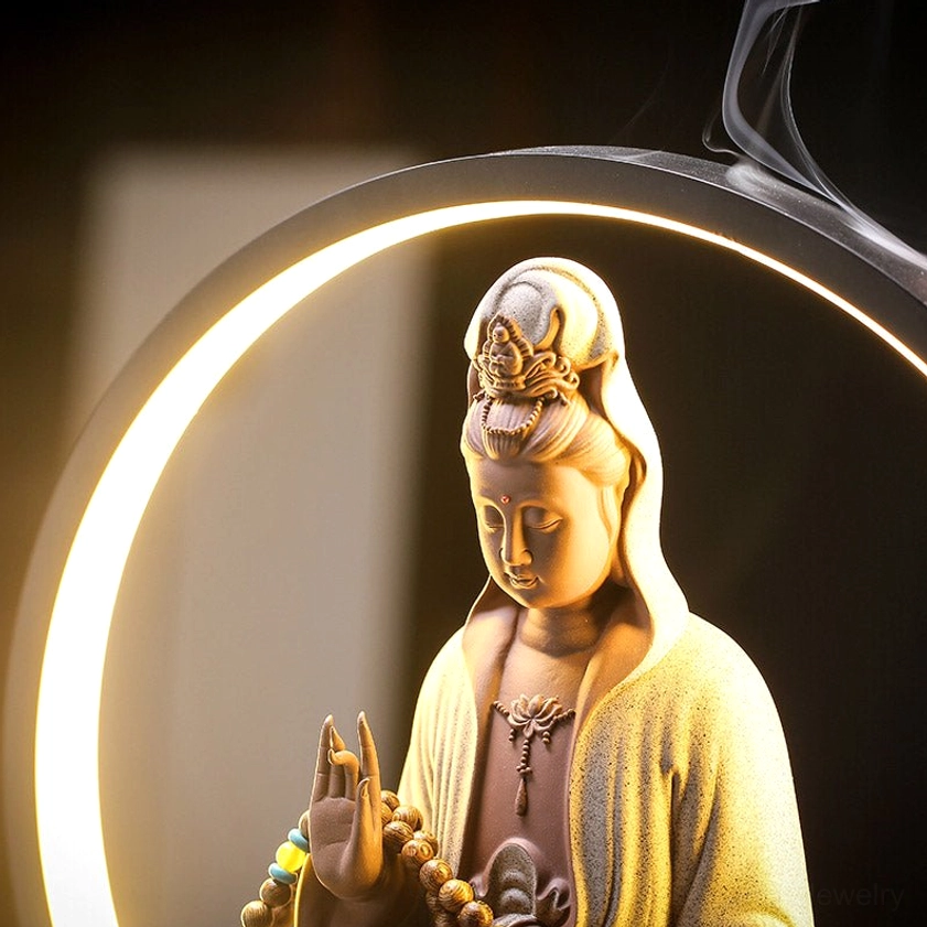White ceramic Avalokitesvara incense burner with prayer beads and warm LED glow for spiritual practice