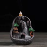 Caves Blessed Place backflow incense burner with mountain village design and flowing incense smoke