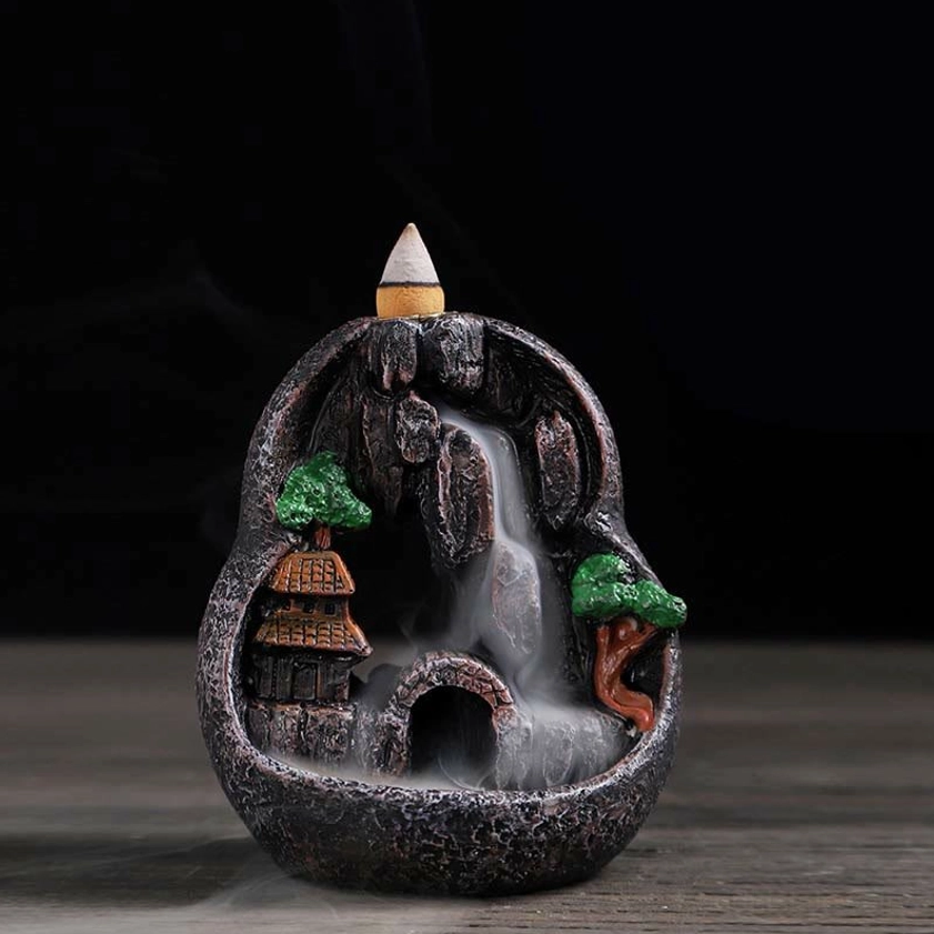 Caves Blessed Place backflow incense burner with mountain village design and flowing incense smoke
