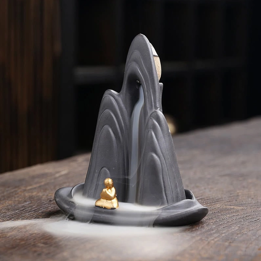 Zen ceramic incense burner showing flowing backflow smoke cascade effect - three quarter angle