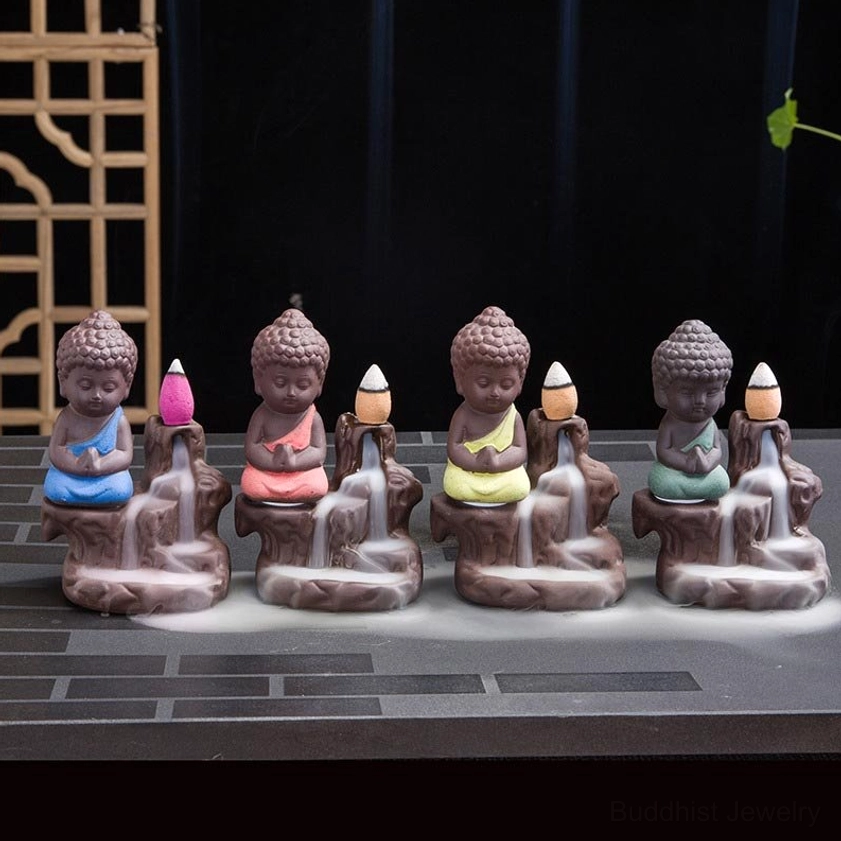 Backflow incense burner in use with fragrant incense cone showing smoke cascade and atmospheric effect