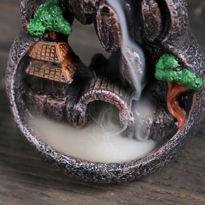 Top-down view of backflow incense burner interior with arched bridge and flowing smoke effect