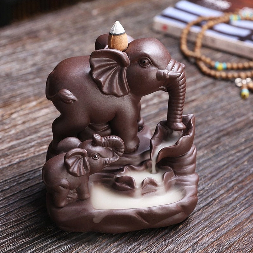 Elephant incense holder with backflow smoke effect and meditation prayer beads and book, top-front perspective