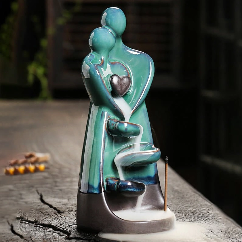 Handcrafted ceramic couple embrace incense burner showing multi-layered smoke cascade paths