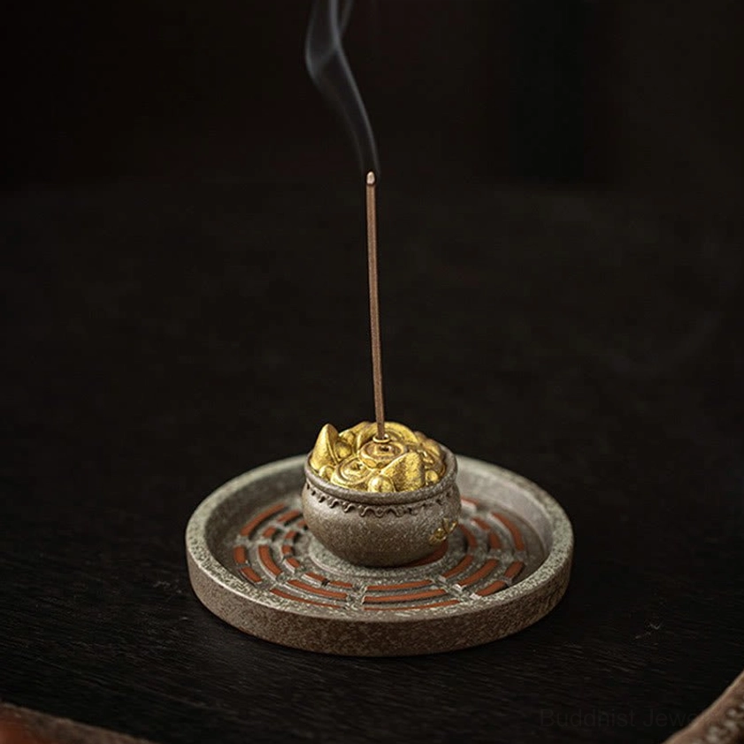 Front eye-level view of red Bagua engraved ceramic incense burner with matte brown finish and standing incense stick