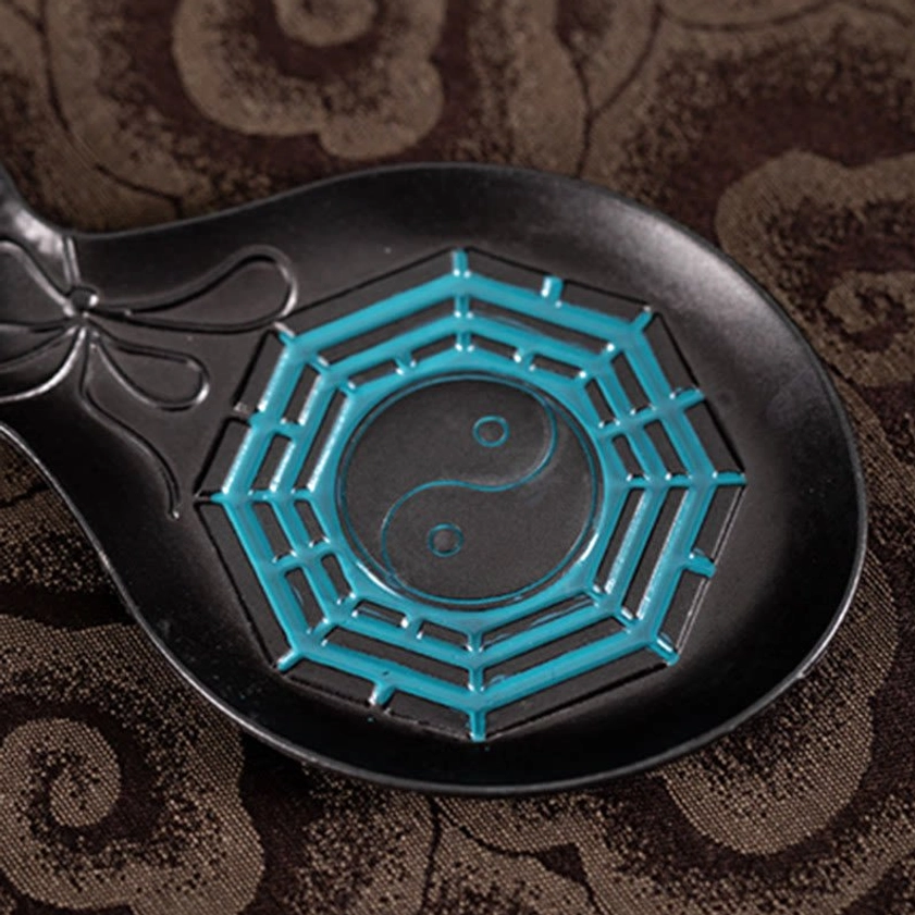 Detailed view of embossed Tai Chi Bagua pattern with three-dimensional cyan relief and bowknot decoration