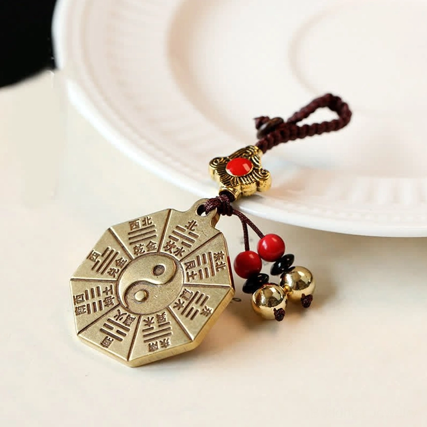 Tai Chi Bagua brass Buddhist keychain with engraved eight trigrams, Chinese characters, red beads and brass bell tassels - front view