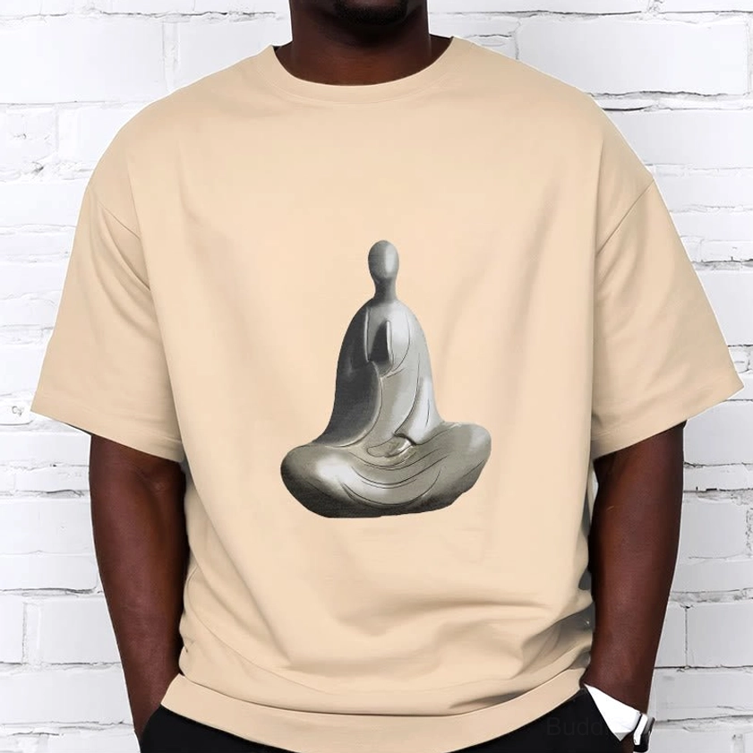Man wearing beige Buddhist t-shirt with formless Buddha print relaxed casual fit brick wall background