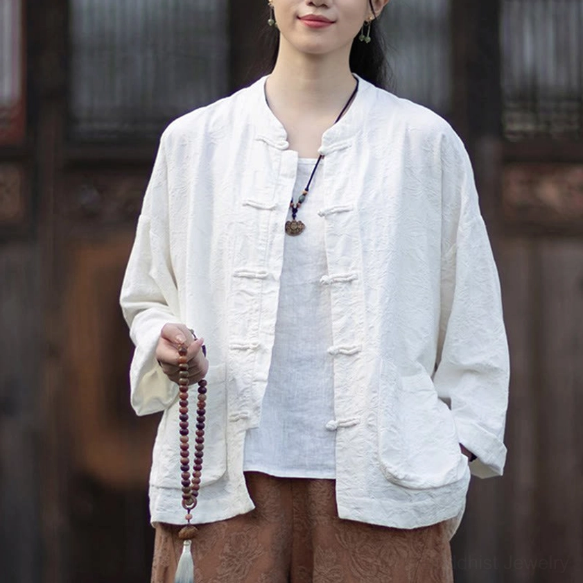 Beige jacquard meditation top with traditional frog button closures and stand collar design
