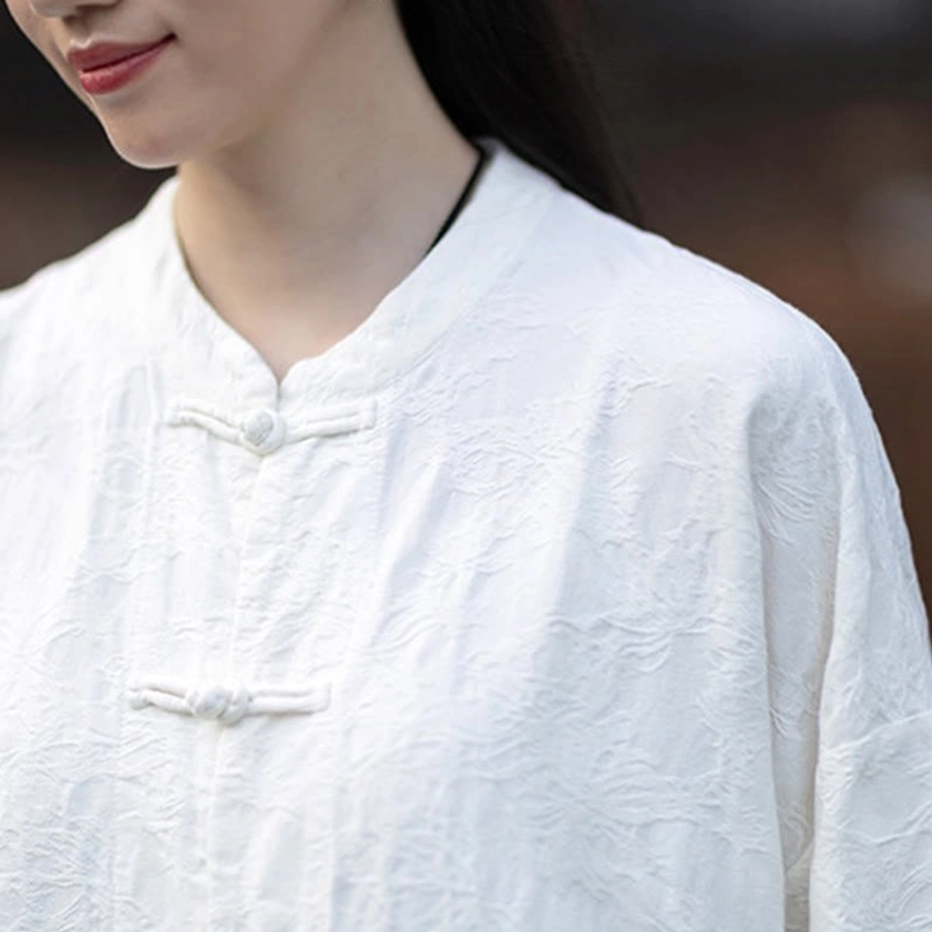 Beige jacquard meditation top with traditional stand collar and soft natural fiber texture