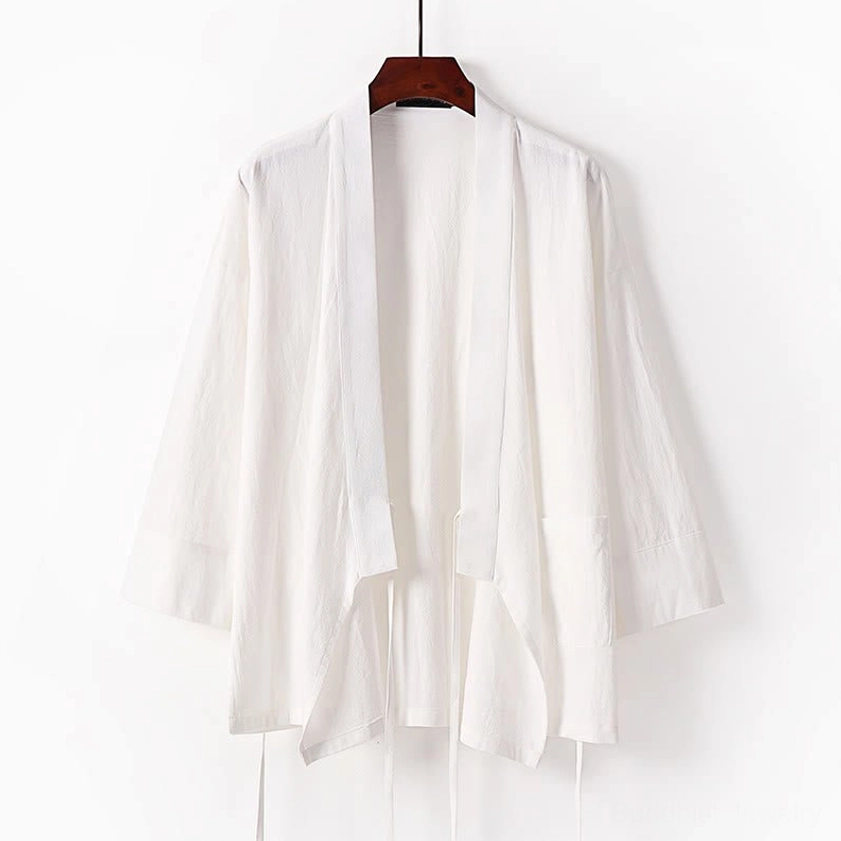 Beige wrap kimono meditation top with tie front and wide sleeves hanging display