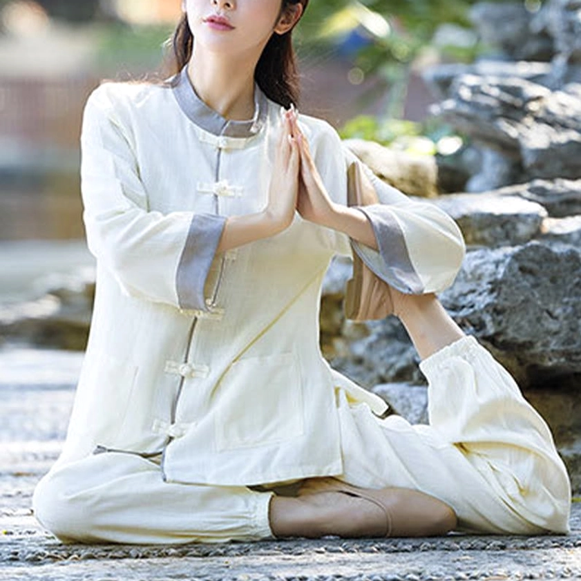 Zen meditation two-piece set in beige, front view with woman in cross-legged yoga pose by rocky waterside